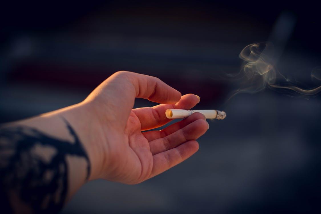 Free Close-up photograph of a person holding a cigarette Stock Photo